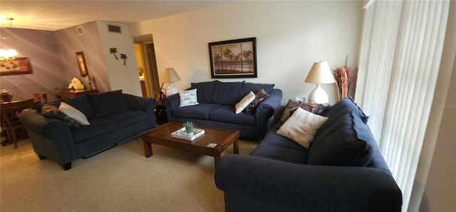 living area with light carpet and visible vents