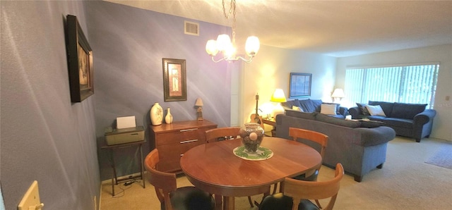 dining room featuring a chandelier, light carpet, and visible vents