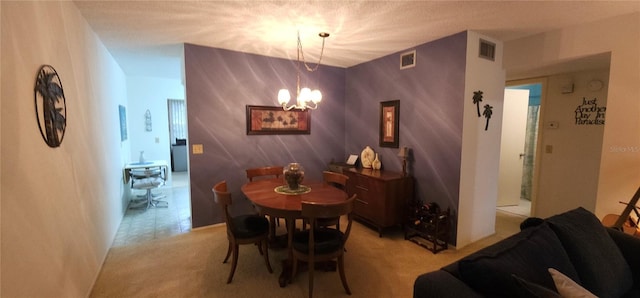 dining space featuring visible vents, a notable chandelier, and light colored carpet