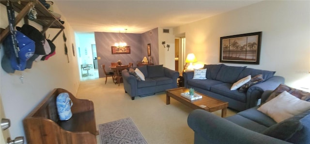 living room with carpet floors, visible vents, and an inviting chandelier