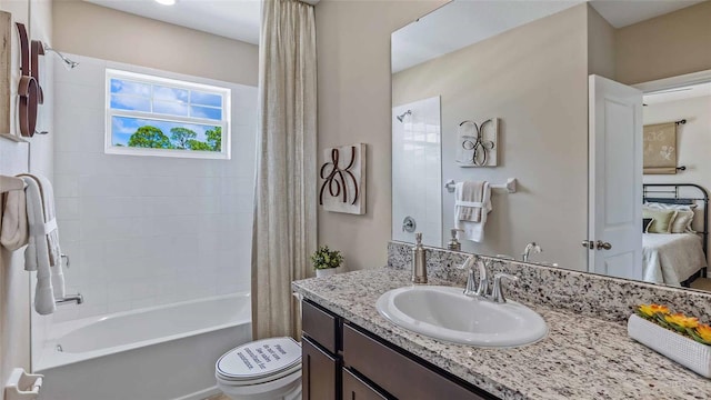 ensuite bathroom featuring toilet, ensuite bathroom, shower / bath combo with shower curtain, and vanity