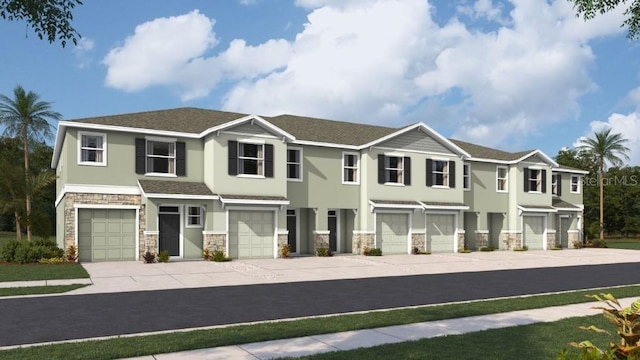 view of front of house featuring a garage, stone siding, concrete driveway, and stucco siding