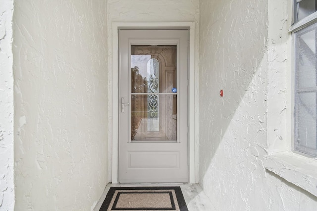 view of exterior entry featuring stucco siding