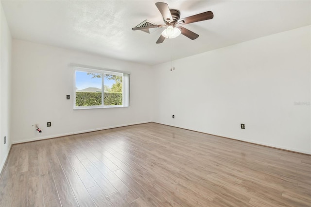 spare room featuring light wood finished floors and ceiling fan