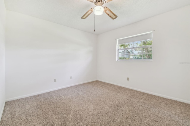 spare room featuring carpet flooring, ceiling fan, a textured ceiling, and baseboards