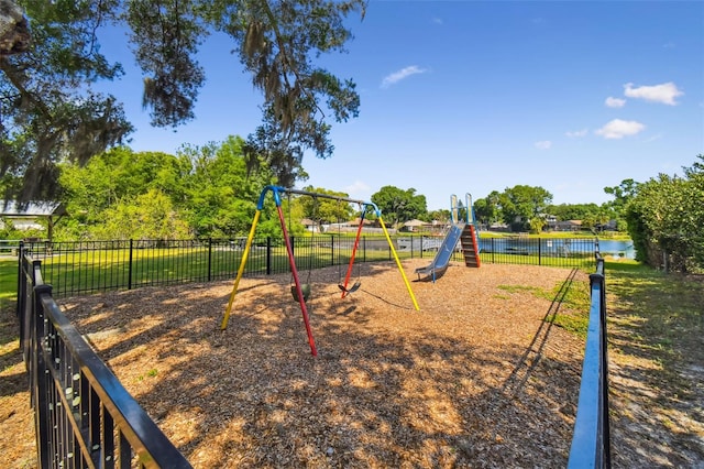 community playground with a water view and fence