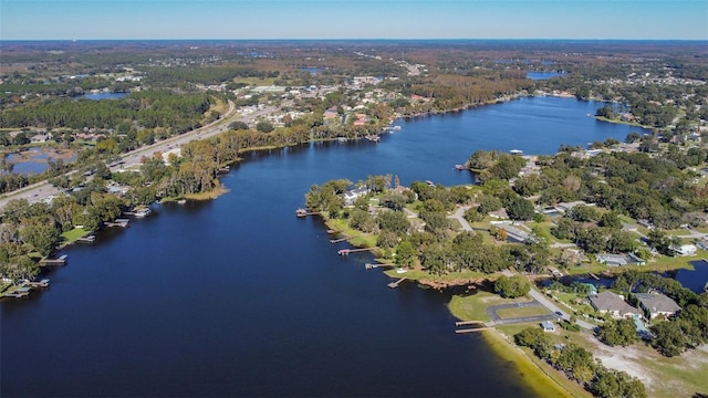 drone / aerial view featuring a water view and a forest view