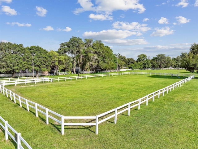 view of yard with a rural view and fence