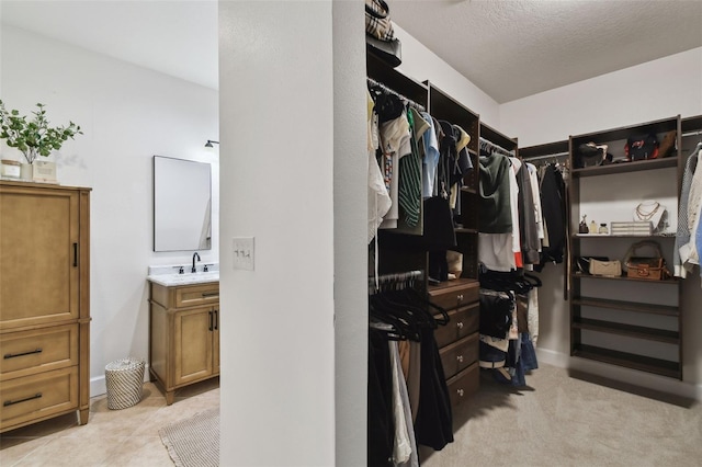 walk in closet featuring a sink