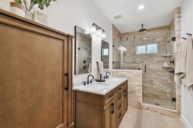 bathroom featuring a stall shower, tile patterned flooring, a sink, and double vanity