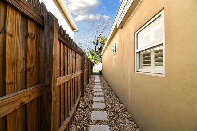 view of home's exterior featuring fence and stucco siding