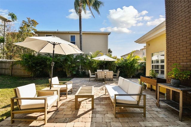 view of patio / terrace with outdoor dining area, fence, and an outdoor living space