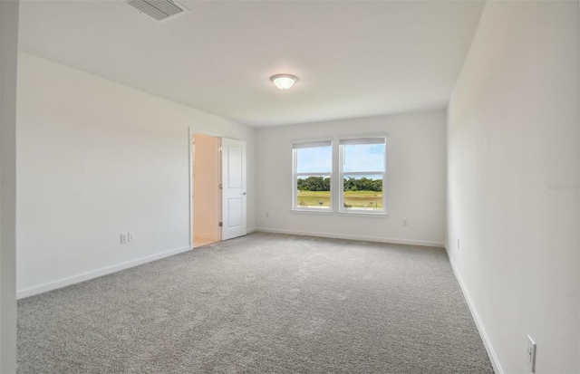 carpeted spare room with baseboards and visible vents