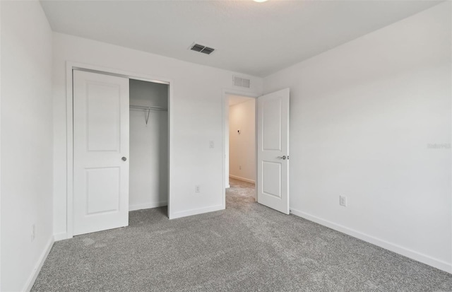 unfurnished bedroom with baseboards, visible vents, and carpet flooring