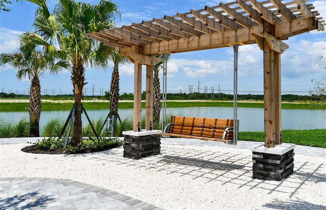 view of patio / terrace featuring a water view and a pergola