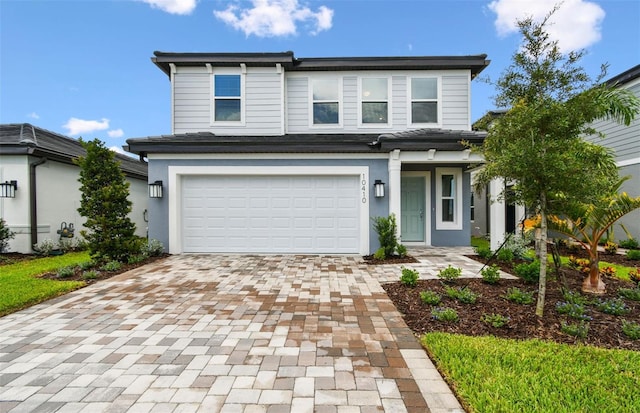 10410 Cross River Trl, Parrish, FL 34219 - view of front of home featuring decorative driveway, a garage, and stucco siding