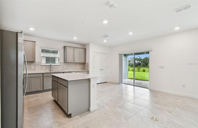 10410 Cross River Trl, Parrish, FL 34219 - kitchen featuring freestanding refrigerator, gray cabinetry, plenty of natural light, and recessed lighting