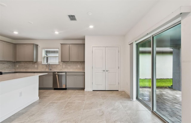 10410 Cross River Trl, Parrish, FL 34219 - kitchen with gray cabinetry, dishwasher, backsplash, light countertops, and recessed lighting