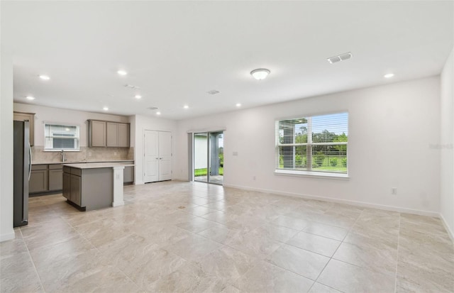 10410 Cross River Trl, Parrish, FL 34219 - kitchen featuring freestanding refrigerator, open floor plan, plenty of natural light, and recessed lighting