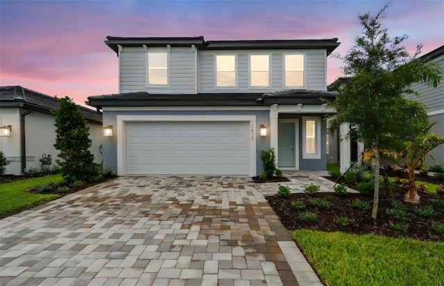 10410 Cross River Trl, Parrish, FL 34219 - view of front of property with an attached garage, decorative driveway, and stucco siding