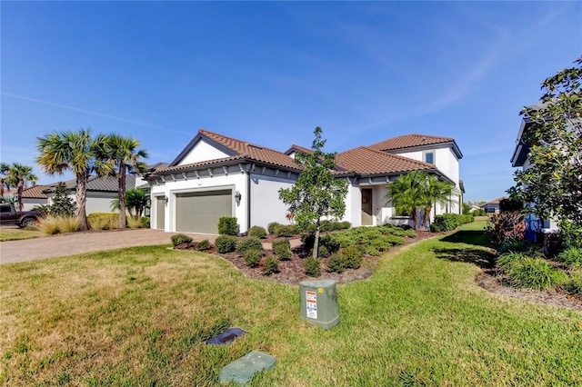 mediterranean / spanish house featuring a garage, a tiled roof, decorative driveway, stucco siding, and a front yard