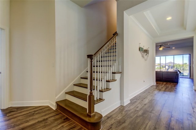 stairway featuring baseboards, ornamental molding, wood finished floors, and recessed lighting