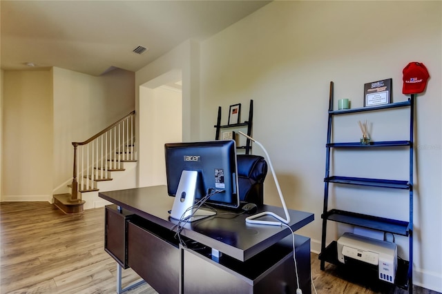 office space with visible vents, baseboards, and wood finished floors