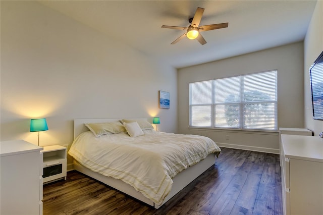 bedroom with ceiling fan, dark wood-type flooring, and baseboards