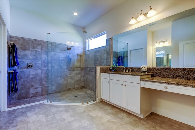 bathroom featuring walk in shower and vanity