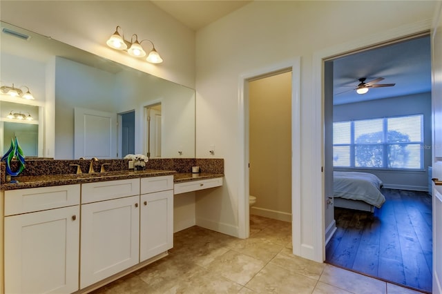 bathroom featuring visible vents, connected bathroom, toilet, tile patterned flooring, and vanity