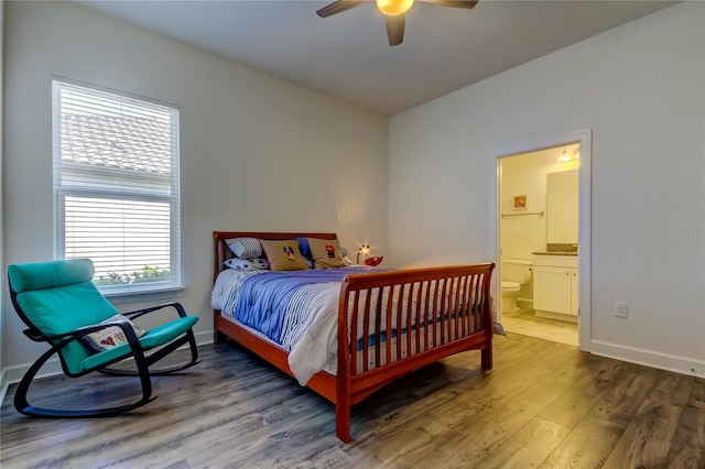 bedroom featuring ceiling fan, connected bathroom, baseboards, and wood finished floors