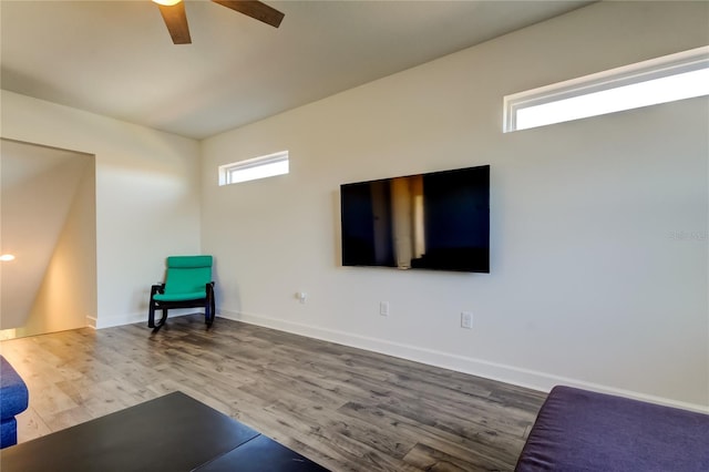 unfurnished room with a ceiling fan, baseboards, and wood finished floors