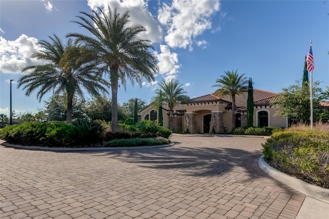 view of front of house featuring a tiled roof and stucco siding