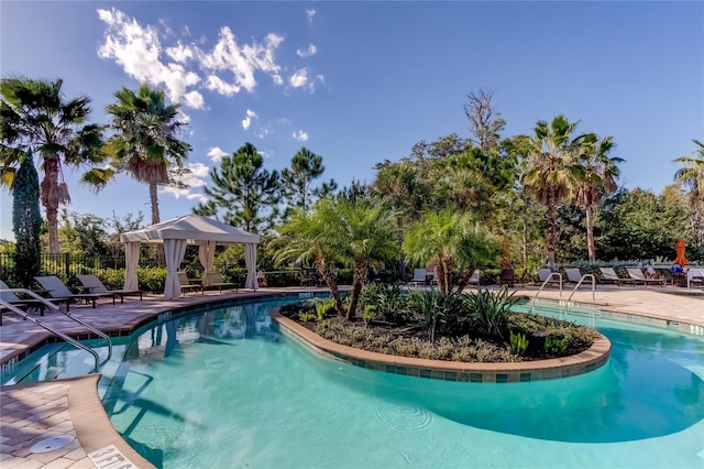 pool with fence and a gazebo