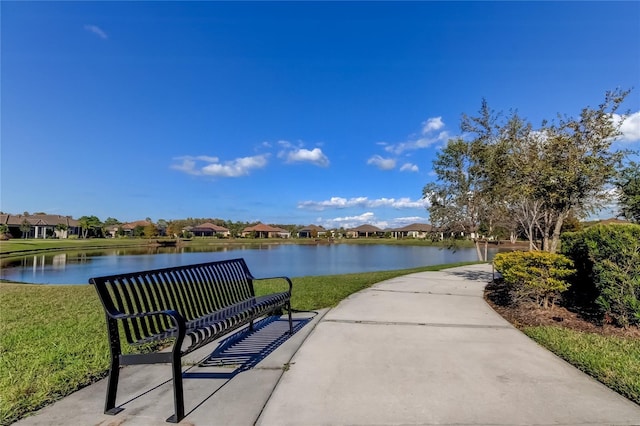 view of community featuring a residential view, a water view, and a yard