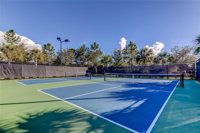 view of tennis court with fence