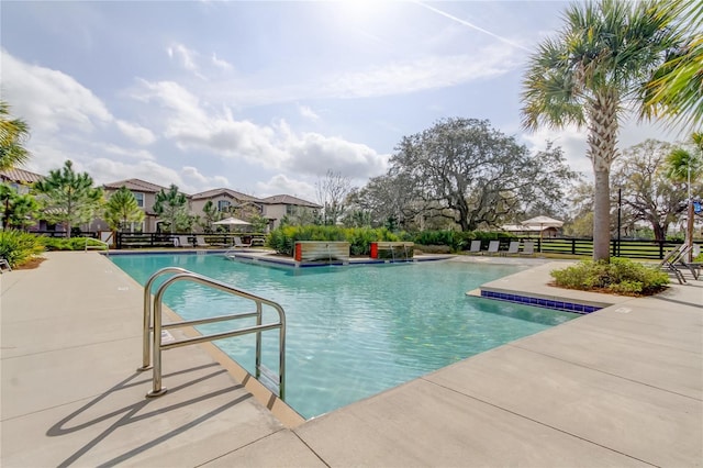 pool with fence and a patio