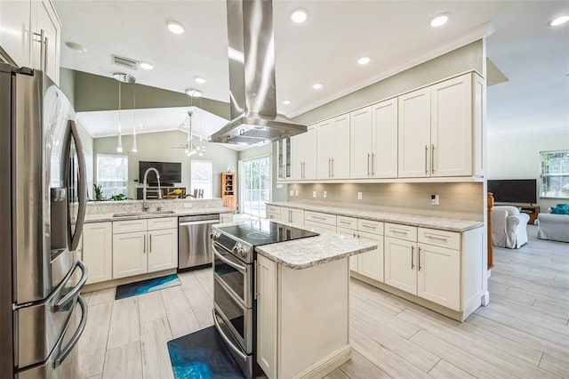 kitchen featuring lofted ceiling, appliances with stainless steel finishes, a sink, island range hood, and light stone countertops