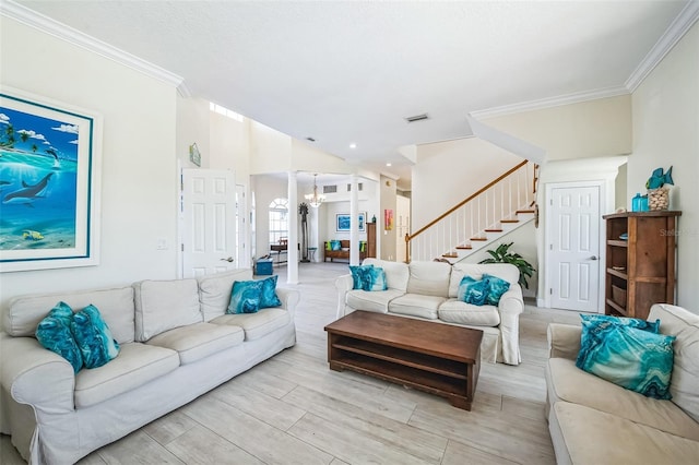 living area featuring crown molding, a notable chandelier, visible vents, stairway, and light wood-style floors