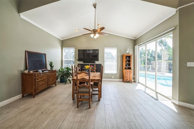 dining space featuring lofted ceiling, light wood-style flooring, and baseboards