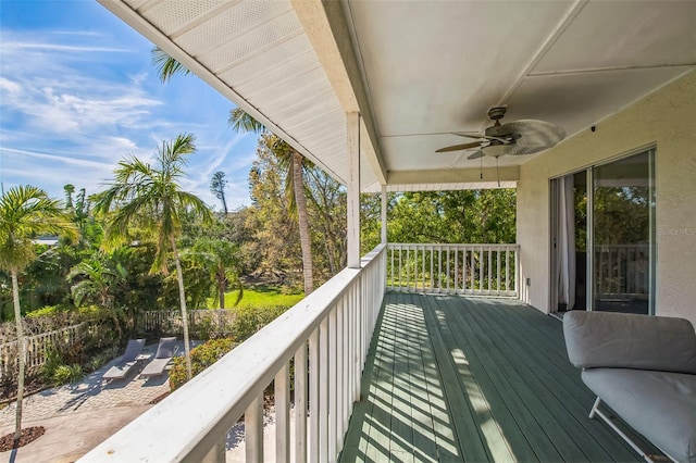 wooden terrace with a ceiling fan