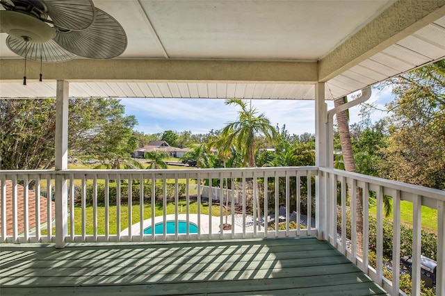 deck with an outdoor pool and a lawn