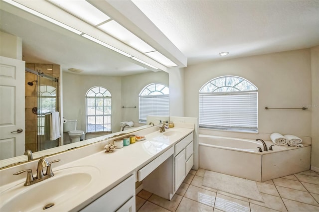 full bathroom featuring a stall shower, a sink, and tile patterned floors