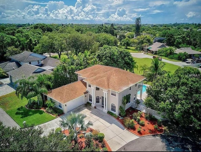 birds eye view of property with a wooded view