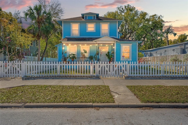 view of front of property with a porch and a fenced front yard