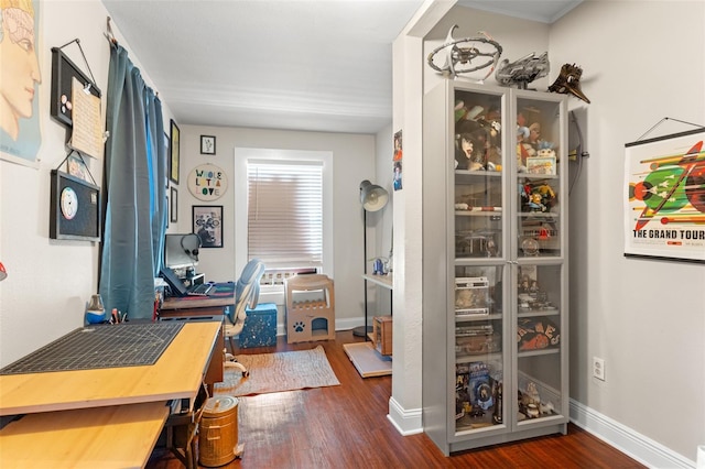 office space featuring baseboards and wood finished floors