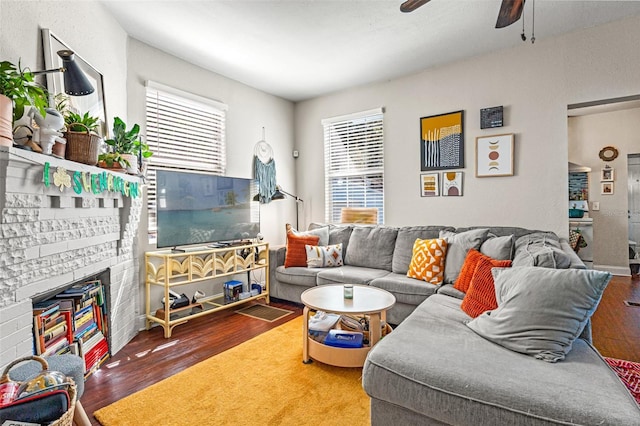 living area with a ceiling fan and wood finished floors