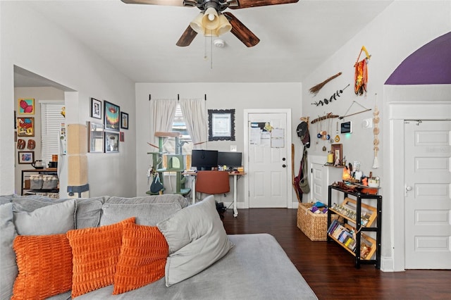 living area featuring ceiling fan, baseboards, and wood finished floors