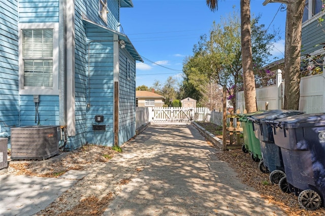 view of street featuring driveway, a gated entry, and a gate