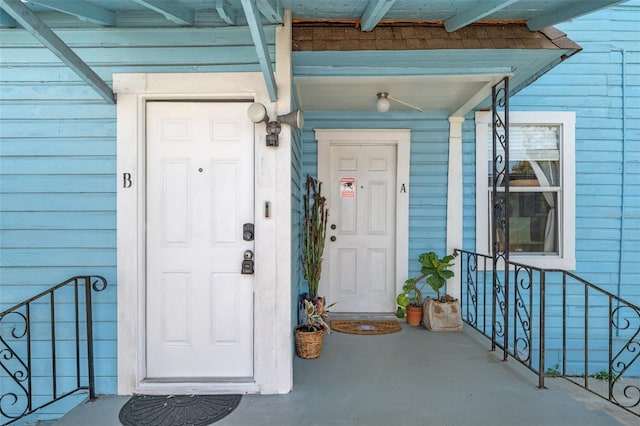 view of exterior entry featuring covered porch